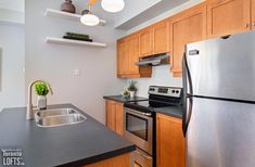 a kitchen with stainless steel appliances and wooden cabinets