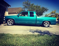 a blue truck parked in front of a house