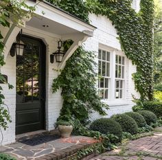 a white house with ivy growing on it's side