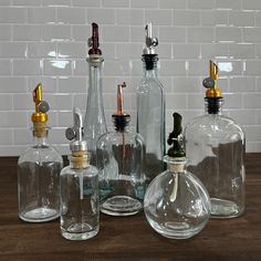 several glass bottles are lined up on a table