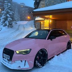 a pink car is parked in the snow