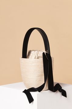 The perfect plus one, finished this season with sumptuous velvet bow. The Party Pail is a slightly scaled down version of the Lunchpail, that easily fits an iPhone + all the essentials you need for the summer soirées ahead. Cesta baskets are handwoven by female artisans in Rwanda, Africa, using locally sourced, renewable resources. Each piece is hand finished in Italy with carefully chosen, sustainable materials. Product Details: 5" W x 5.3" T x 5" D Handle: Italian Velvet Backed in Vegetable Ta Rwanda Africa, Lunch Pail, Black Basket, Black Velvet Bow, Velvet Bow, Basket Bag, Women Artisans, Velvet Ribbon, Woven Bag