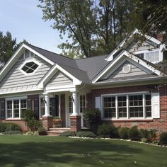 a brick house with white trim and black shutters