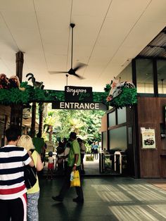 people are standing in front of the entrance to an event