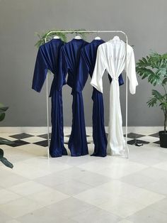 Bridesmaid robes in long length in softest navy, ice, blue. silver satin. Personalized custom bridal party robes for mother of the bride and groom. Indulge in the epitome of elegance with our long-length, softest satin robes in enchanting navy, ice blue, and silver hues. Elevate your bridal party experience with personalized robes that redefine luxury. Crafted with precision, our custom kimonos are perfect for the mother of the bride, mother of the groom, and every cherished member of your brida Bridal Entourage, Personalized Robes, Satin Robes, Personalized Robe, Bridal Party Robes, Bridesmaid Robes, Custom Bridal, Bridal Robes, Wedding Moments