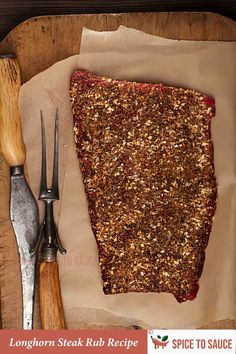 a wooden cutting board topped with sliced up food next to utensils and spoons