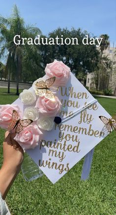 a graduation cap with flowers and butterflies on it that reads, graduation day when you're