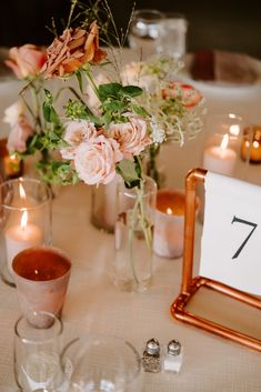 the table is set with flowers and candles