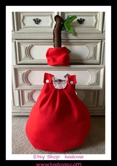 a red purse sitting on top of a white dresser