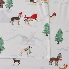 two sheets with dogs and santa hats on them