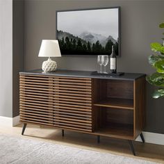 a wooden sideboard with two wine glasses on it and a painting in the background