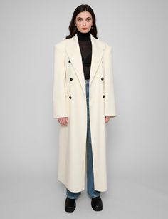 Off-white wool oversized coat with padded dropped shoulders and contrast buttons . Brand Pixie Market Dropped shoulders 100% woolSide pockets Size S: shoulder 20"/50cm bust 39"/98 length 51"/128 cm sleeve length25"/62.5 cmSize M: shoulder 21"/51 bust 41"/102cm length /52"/130.5 cm sleeve length25.5"/26.5cmModel is wearing a size small and model's height is 5.7"/170 cmImported ​ Oversized Long Wool Coat With Buttons, White Wool Coat For Work In Fall, Cream Wool Coat With Button Closure For Fall, White Wool Long Coat, White Wool Coat For Winter, Cream Winter Business Outerwear, White Long Wool Coat For Fall, White Wool Outerwear With Buttons, Winter White Wool Long Coat