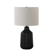 a black table lamp with a white shade on the top, and a light grey base