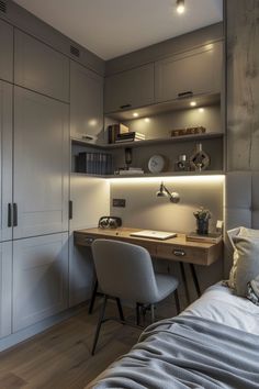 a bed sitting next to a wooden desk in a room with lots of cupboards