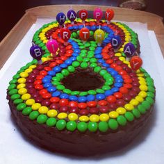 a chocolate birthday cake decorated with colorful candies