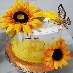 a cake decorated with sunflowers and butterflies