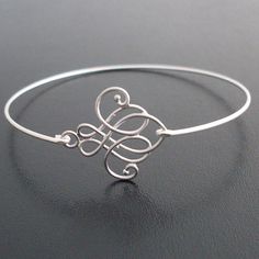 a silver bracelet with an initial on it