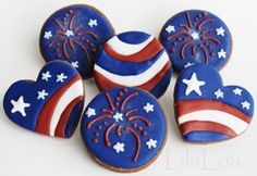 decorated cookies with red, white and blue icing in the shape of heart shapes