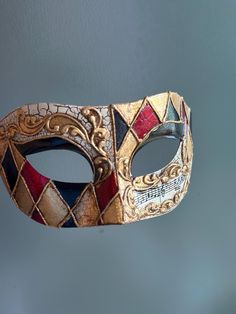 This Venetian style mask in red, black, and gold is perfect for any formal occasion or masquerade event! Thank you for supporting small businesses and hope our products bring you and loved ones some joy and humor in these trying times.    I N C L U D E D Masks come with matching double sided satin ribbons attached. S I Z E  Adult size. Detailed dimensions available upon request. C U S T O M I Z A T I O N If you would like to color & embellish the mask to match your costume/dress, choose custom color and get in touch, we love to work on custom orders!  C O N T A C T  Please contact us via ETSY messages. P H O T O  Images displayed on this listing are property of www.higginscreek.com A B O U T HigginsCreek makes elegant face Masks for masquerade balls, Prom Dances, Bachelorette parties, Grad Masqurade Mask, Painted Masquerade Mask, Mens Mask, Masquerade Event, Masquerade Mask Diy, Harlequin Mask, Elegant Face Mask, Masquerade Prom, Mens Masquerade Mask