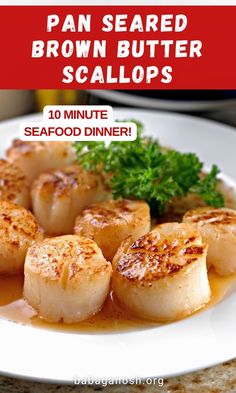 a white plate topped with scallops covered in sauce