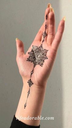 a woman's hand with a tattoo on it