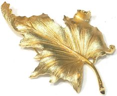 This stylish large vintage Crown Trifari brooch features a   brushed gold tone leaf with a shiny textured gold tone outline.  The brooch measures 3" x 2" with a roll over clasp and is in very good/excellent condition with the gold tone finish nice and bright.  Signed Trifari with crown over T (c) and weighs 26 grams Shipping prices vary on the weight of item. I do my best to keep shipping costs reasonable. The prices quoted are not trackable and is the least expensive airmail postage for most co Elegant Carved Gold Brooches, Collectible Carved Gold Brooches, Ornate Carved Gold Brooches, Ornate Gold Carved Brooches, Vintage Gold Leaf-shaped Jewelry, Trifari Brooch, Vintage Crown, Crown Trifari, Leaf Brooch