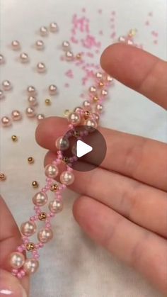 someone is making beaded bracelets out of pearls