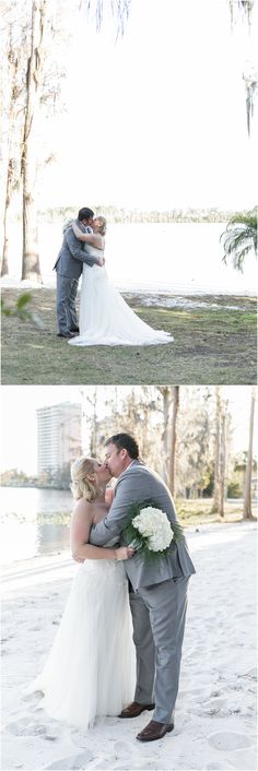 a bride and groom kissing on the beach in front of some trees with their arms around each other