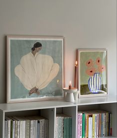 two bookshelves with pictures and candles on them