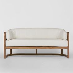 a white couch sitting on top of a wooden frame