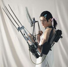 a woman is holding two large metal swords