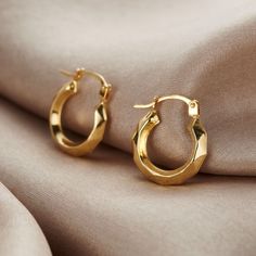 These creole earrings are made from pure 9ct yellow gold. Designed with a unique harlequin pattern, each of these hoops has a stunning faceted textured finish. This results in a beautiful eye-catching gold hoop earring that catches the light from each direction. The perfect gift for yourself or someone special who deserves a little extra sparkle in their life. Please note that earrings are non-returnable for reasons of hygiene and safety. Made from: These earrings are made from 9ct Yellow Gold. Diamond Cut Gold Plated Huggie Earrings, Diamond Cut Huggie Gold Plated Hoop Earrings, Diamond Cut Huggie Hoop Earrings Gold Plated, Modern Gold Diamond Cut Huggie Earrings, Modern Gold Huggie Earrings With Diamond Cut, Modern Hoop Earrings With Diamond Cut For Gift, Diamond Cut Huggie Hoop Earrings As Gift, Posh Totty, Gold Hoop Earring