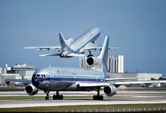 an airplane is about to take off from the tarmac with another plane in the background