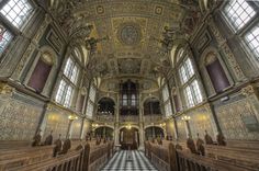 the interior of an old church with stained glass windows