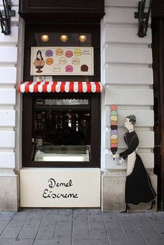 a street scene with focus on the doughnuts and ice cream shop front window