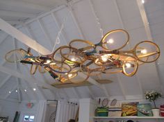 a chandelier made out of tennis rackets hanging from the ceiling in a room