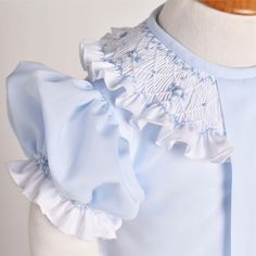 There is just so much beauty in simplicity… This absolutely defines our Alice Collection! We have designed the most darling “season-less” styles, dainty yet detail rich that with certainty, will always be in style no matter what time of year! Made from soft blue cotton batiste, Alice Bubble has a pronounced central pleat that has been intricately decorated with a white batiste hand smocked collar, making perfect contrast. Rococo Flowers, Smocking Fashion, Baby Heirloom, Smocking Plates, Hand Smocked Dress, Smocked Baby Dresses, Smocking Patterns, Smocked Clothes, Silhouette Dress