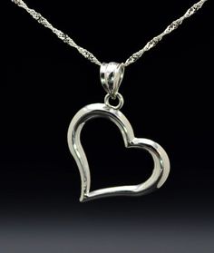 The Varenna Ladies Contemporary 14K White Gold Heart Necklace. Dangling from a 16 inch chain is a 0.75 inch white gold heart pendant. The perfect gift for that special someone. Each piece has been hand selected and meticulously identified and graded by a Graduate Gemologist who has been awarded a degree by the Gemological Institute of America (GIA). Please visit our Shop's About Page or our website for more information about our jewelry. Sizing for all rings is an additional charge and will be d Classic White Gold Jewelry With Heart Charm, Elegant Sterling Silver Heart Pendant Necklace, Classic Sterling Silver Jewelry For Valentine's Day, Elegant Sterling Silver Heart Necklace With Polished Finish, Elegant Sterling Silver Hallmarked Heart Necklace, Classic Sterling Silver Heart Necklace For Anniversary, Elegant Sterling Silver Open Heart Jewelry, Classic Sterling Silver Heart Pendant Necklace, Sterling Silver Diamond Cut Heart Pendant Jewelry