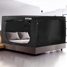 a bed that is in the shape of a tent with pillows on it and an open door