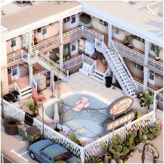 an aerial view of a motel with cars parked in the parking lot and stairs leading up to it