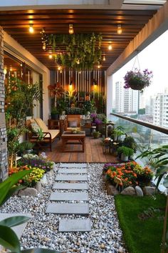 an outdoor patio with lots of plants and rocks