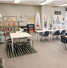 a classroom with several tables and chairs in front of the desks on the floor