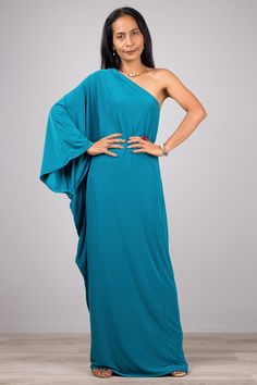 "One shoulder dress, Long teal dress, Off shoulder evening dress  PRODUCT SIZE : Free Size * Chest : 40\" will stretch to 44\"  * Waist : 40\" will stretch to 42\" * Hips : 40\" will stretch to 42\" * Sleeve length : 23\" * Length : 56\" - 57\" from shoulder to hem (measured when laying flat) If your chest measurement is below 34\", the dress will be too big for you MATERIAL : * Polyester spandex \" Venetia\" > soft and comfortable to wear NOTE :  * Model chest : 32\", waist : 24\" hips : 35\" Blue Asymmetrical One Shoulder Dress For Prom, One-shoulder Green Evening Dress, One Shoulder Maxi Dress For Evening, Green One-shoulder Maxi Dress For Evening, Summer Prom One Shoulder Draped Dress, Summer Prom One-shoulder Draped Dress, Elegant Blue Draped One-shoulder Dress, Blue One-shoulder Dress With Asymmetrical Neckline For Evening, Elegant Blue Draped One Shoulder Dress