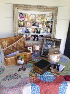 a table topped with pictures and other items on top of a quilt covered table cloth