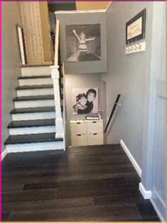 the stairs in this house have been painted gray and white with pictures on each wall