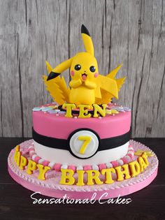 a birthday cake decorated with a pikachu figure and the number seven on it