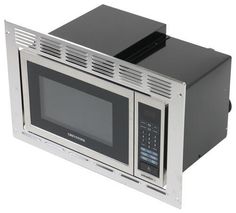 a microwave oven sitting on top of a white counter next to a black and silver door