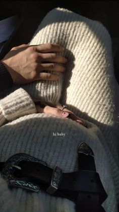 a person is holding their hand on the back of a car seat, while it's covered in a blanket