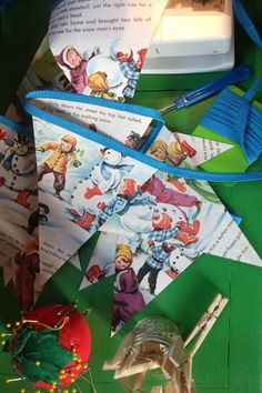 an ornament and some christmas cards on a green table with blue stringing