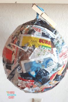 a paper mache hanging from the side of a wall with stickers all over it